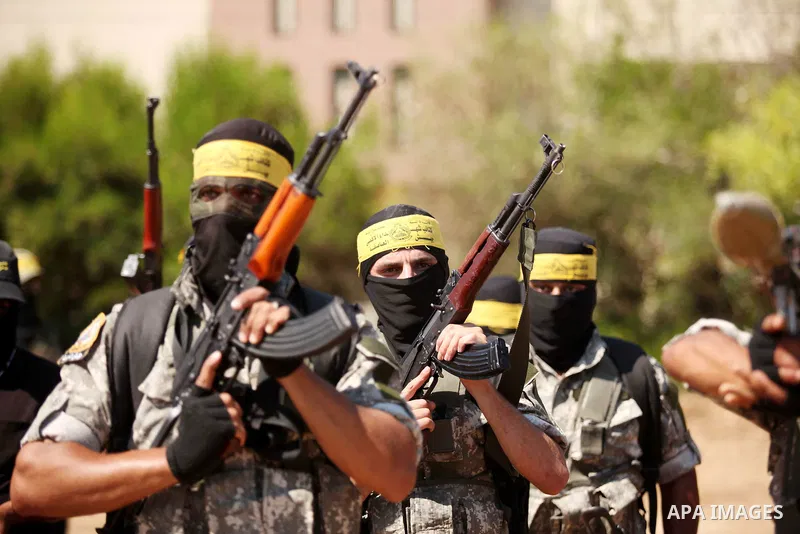 Palestinian militants of al-Aqsa brigades, the armed wing of Fatah movement, celebrate the release of prisoner Mahmoud Abu Amra from an Israeli jail, in Deir al-Balah in the central Gaza Strip, July 30, 2015. Abu Amra se...