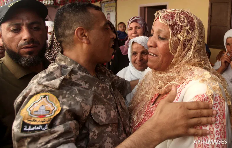Freed Palestinian prisoner Mahmoud Abu Amra is welcomed by a relative upon his release from an Israeli jail, at his home in Deir al-Balah in the central Gaza Strip, July 30, 2015. Abu Amra served 12 years in the Israeli...