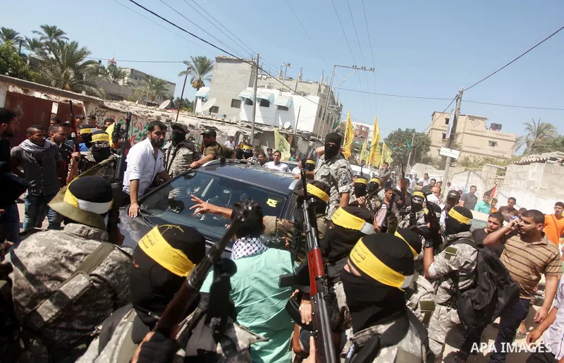 Palestinian militants of al-Aqsa brigades, the armed wing of Fatah movement, celebrate the release of prisoner Mahmoud Abu Amra from an Israeli jail, in Deir al-Balah in the central Gaza Strip, July 30, 2015. Abu Amra se...