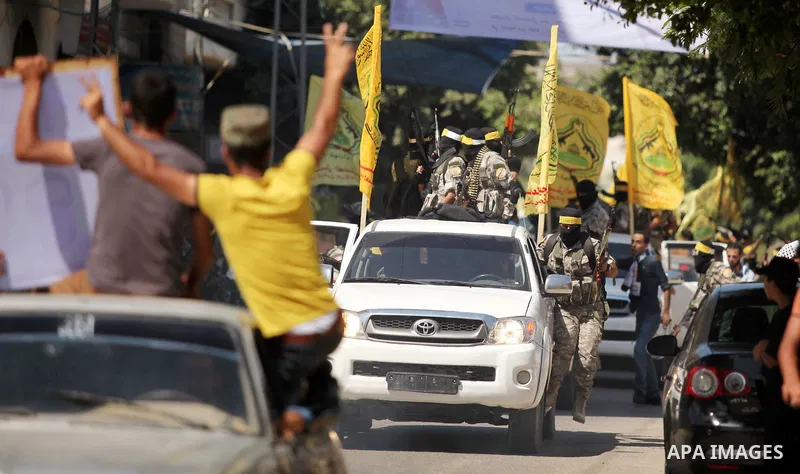 Palestinian militants of al-Aqsa brigades, the armed wing of Fatah movement, celebrate the release of prisoner Mahmoud Abu Amra from an Israeli jail, in Deir al-Balah in the central Gaza Strip, July 30, 2015. Abu Amra se...