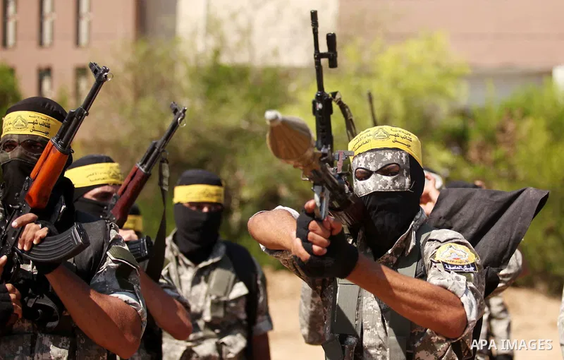 Palestinian militants of al-Aqsa brigades, the armed wing of Fatah movement, celebrate the release of prisoner Mahmoud Abu Amra from an Israeli jail, in Deir al-Balah in the central Gaza Strip, July 30, 2015. Abu Amra se...