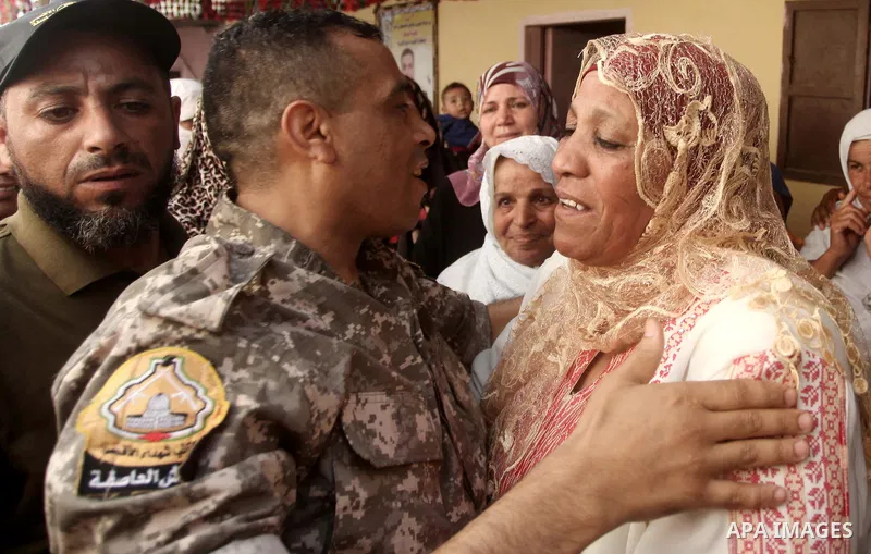 Freed Palestinian prisoner Mahmoud Abu Amra is welcomed by a relative upon his release from an Israeli jail, at his home in Deir al-Balah in the central Gaza Strip, July 30, 2015. Abu Amra served 12 years in the Israeli...