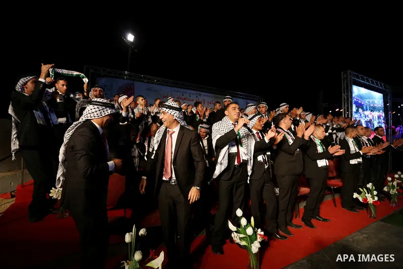 Palestinian grooms take part in a mass wedding ceremony in the West Bank city of Nablus, on July 30, 2015. Nearly 120 Palestinian couples were married in a ceremony supported by Palestinian President Mahmoud Abbas. Photo...