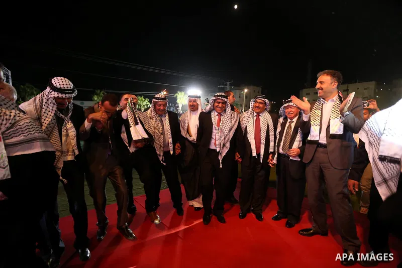 Palestinian grooms take part in a mass wedding ceremony in the West Bank city of Nablus, on July 30, 2015. Nearly 120 Palestinian couples were married in a ceremony supported by Palestinian President Mahmoud Abbas. Photo...