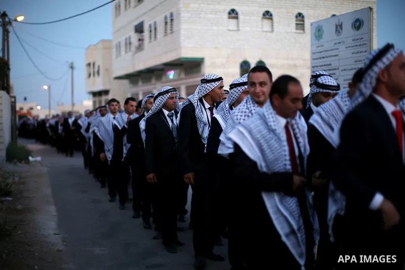 Palestinian grooms take part in a mass wedding ceremony in the West Bank city of Nablus, on July 30, 2015. Nearly 120 Palestinian couples were married in a ceremony supported by Palestinian President Mahmoud Abbas. Photo...