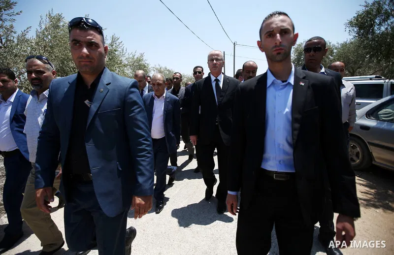 Palestinian Prime Minister Rami Hamdallah attends the funeral of 18-month-old Palestinian baby Ali Dawabsheh, who was killed after his family's house was set on fire in a suspected attack by Jewish extremists in Duma vil...