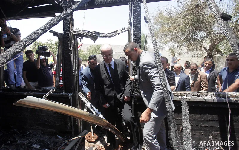 Palestinian Prime Minister Rami Hamdallah inspects the Dawabsheh home that was badly damaged from a suspected attack by Jewish extremists on two houses in the West Bank village of Douma near Nablus City, 31 July 2015. Su...