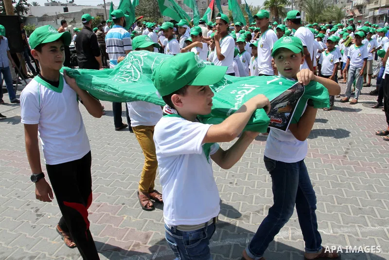 Palestinian children carry a funeral stretcher with a picture of 18-month-old Ali Saad Dawabsha, the toddler who was burned to death by suspected Jewish extremists, on August 1, 2015 in Khan Yunis in the southern Gaza St...