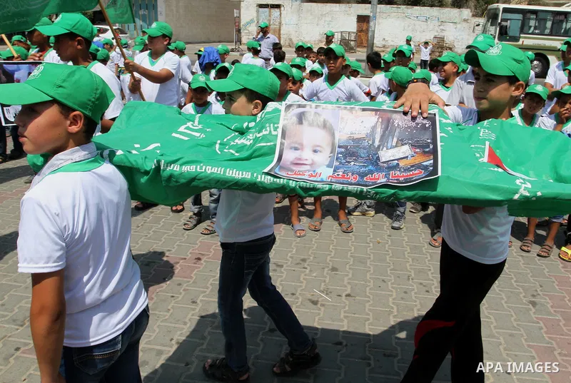 Palestinian children carry a funeral stretcher with a picture of 18-month-old Ali Saad Dawabsha, the toddler who was burned to death by suspected Jewish extremists, on August 1, 2015 in Khan Yunis in the southern Gaza St...