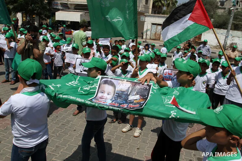 Palestinian children carry a funeral stretcher with a picture of 18-month-old Ali Saad Dawabsha, the toddler who was burned to death by suspected Jewish extremists, on August 1, 2015 in Khan Yunis in the southern Gaza St...