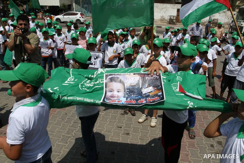 Palestinian children carry a funeral stretcher with a picture of 18-month-old Ali Saad Dawabsha, the toddler who was burned to death by suspected Jewish extremists, on August 1, 2015 in Khan Yunis in the southern Gaza St...