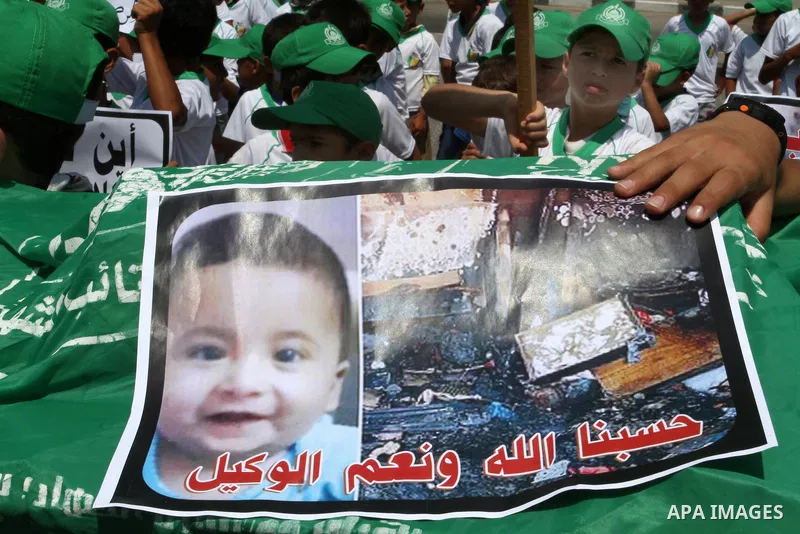 Palestinian children carry a funeral stretcher with a picture of 18-month-old Ali Saad Dawabsha, the toddler who was burned to death by suspected Jewish extremists, on August 1, 2015 in Khan Yunis in the southern Gaza St...