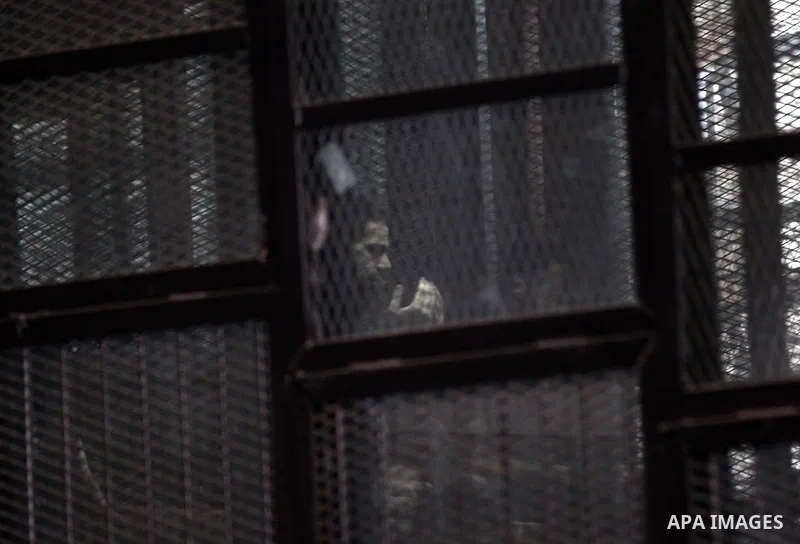 Egyptian radical Islamist Mohammed al-Zawahiri, the brother of Al-Qaeda chief Ayman al-Zawahiri, sits in the defendants cage during his trial with 68 other defendants, at a court in Cairo on August 01, 2015. Photo by Amr...