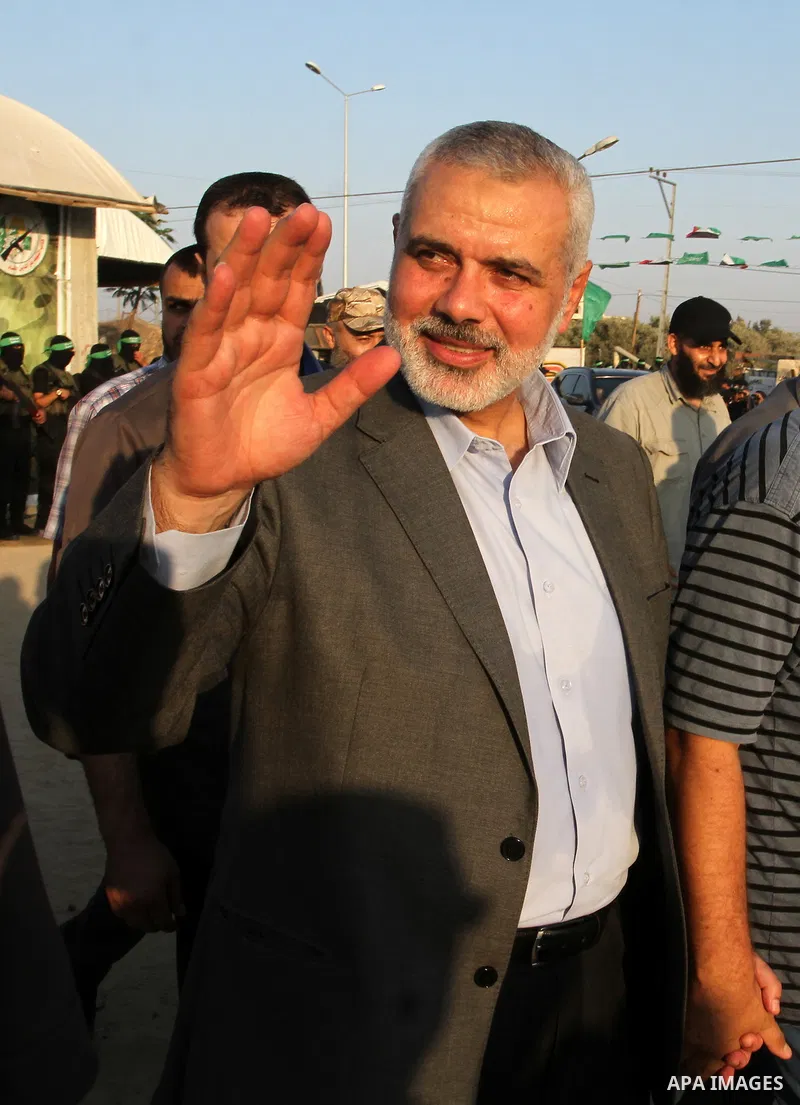 Senior Hamas leader Ismail Haniyeh waves as he arrives to Liberation Youths summer camp, organised by the Hamas movement, in Rafah in the southern Gaza Strip, August 1, 2015. Hamas stages dozens of military-style summer...