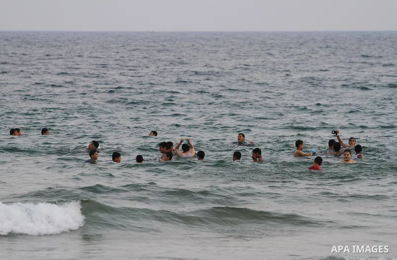 Palestinians enjoy the warm weather on a beach along the Mediterranean Sea in Gaza city, on August 2, 2015. Photo by Mohammed Asad