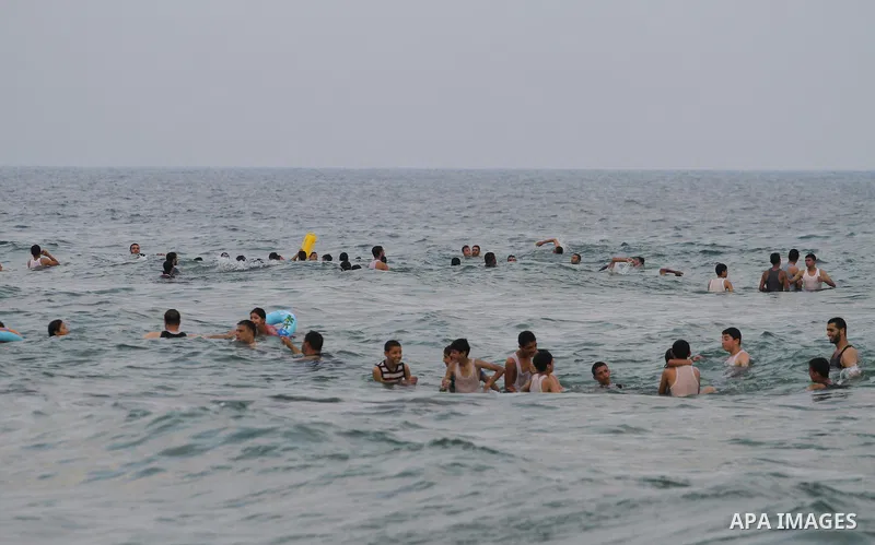 Palestinians enjoy the warm weather on a beach along the Mediterranean Sea in Gaza city, on August 2, 2015. Photo by Mohammed Asad