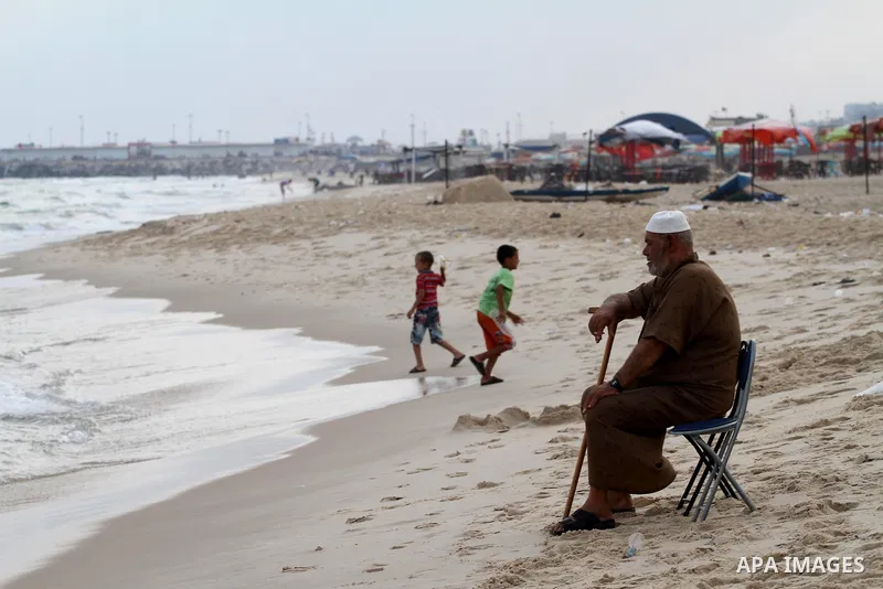 Palestinians enjoy the warm weather on a beach along the Mediterranean Sea in Gaza city, on August 2, 2015. Photo by Mohammed Asad