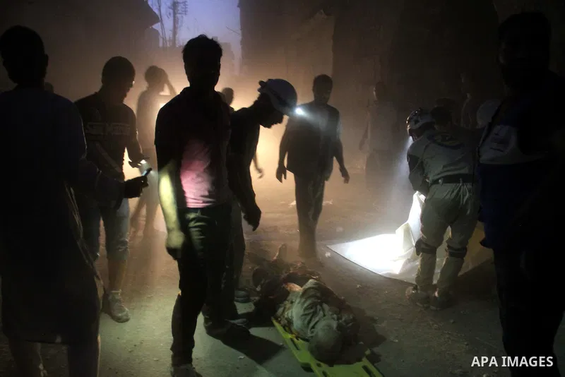 Syrian civil defence members stand next to the body a man killed following a reported bomb barrel attack by forces of Syria's President Bashar al-Assad at the old city of Aleppo, on August 2, 2015. At least 1 civilian ki...