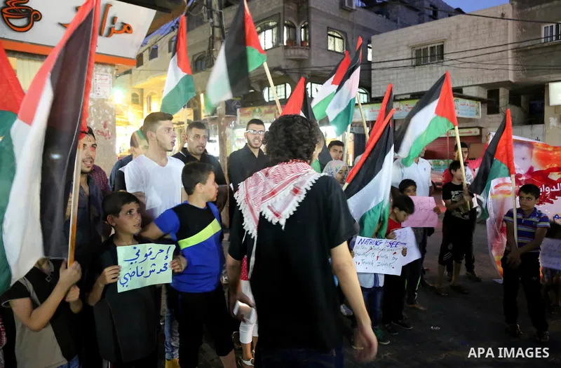 Palestinians take part in a candle vigil in a protest against the killing of 18-month-old Palestinian Ali Saad Dawabsheh, the toddler who was burned to death by suspected Jewish extremists, in Jabalia in the northern Gaz...