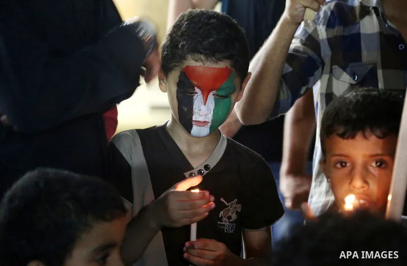 Palestinian children take part in a candle vigil in a protest against the killing of 18-month-old Palestinian Ali Saad Dawabsheh, the toddler who was burned to death by suspected Jewish extremists, in Jabalia in the nort...