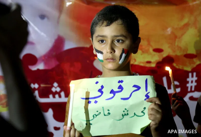 Palestinian children take part in a candle vigil in a protest against the killing of 18-month-old Palestinian Ali Saad Dawabsheh, the toddler who was burned to death by suspected Jewish extremists, in Jabalia in the nort...