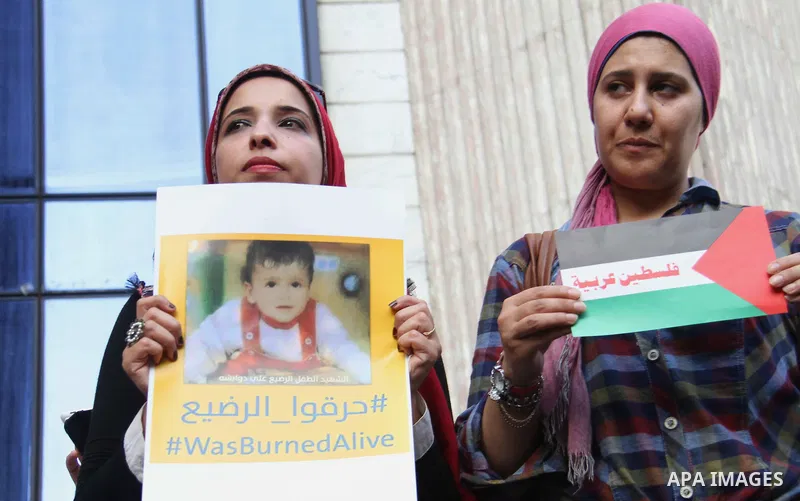 Egyptian journalists take part in a protest against the killing of 18-month-old Palestinian Ali Saad Dawabsheh, the toddler who was burned to death by suspected Jewish extremists, in front of the Journalists Syndicate, i...