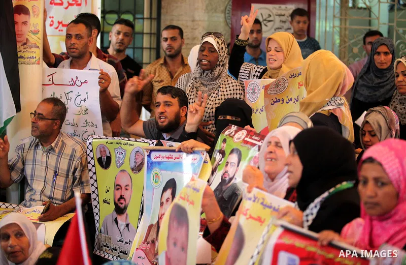 Palestinians take part in a protest demanding release the prisoners in Israeli jails, in front of Red cross office, in Gaza city, on on August 03, 2015. Photo by Ashraf Amra