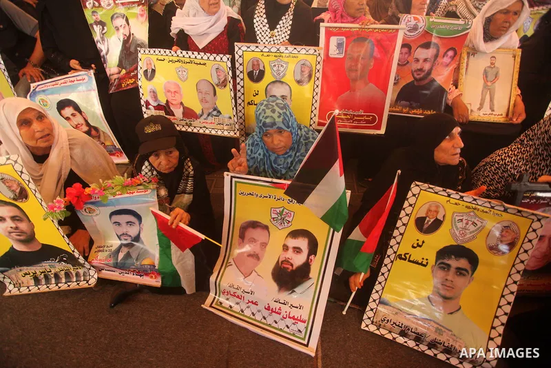 Palestinians take part in a protest demanding release the prisoners in Israeli jails, in front of Red cross office, in Gaza city, on on August 03, 2015. Photo by Ashraf Amra
