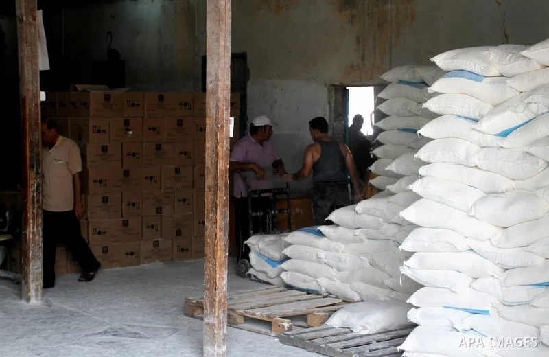 Palestinians receive food aid at an aid distribution centre of the United Nations Relief and Works Agency (UNRWA) in Rafah in the southern Gaza Strip on August 4, 2015. The United Nations Relief and Works Agency for Pale...