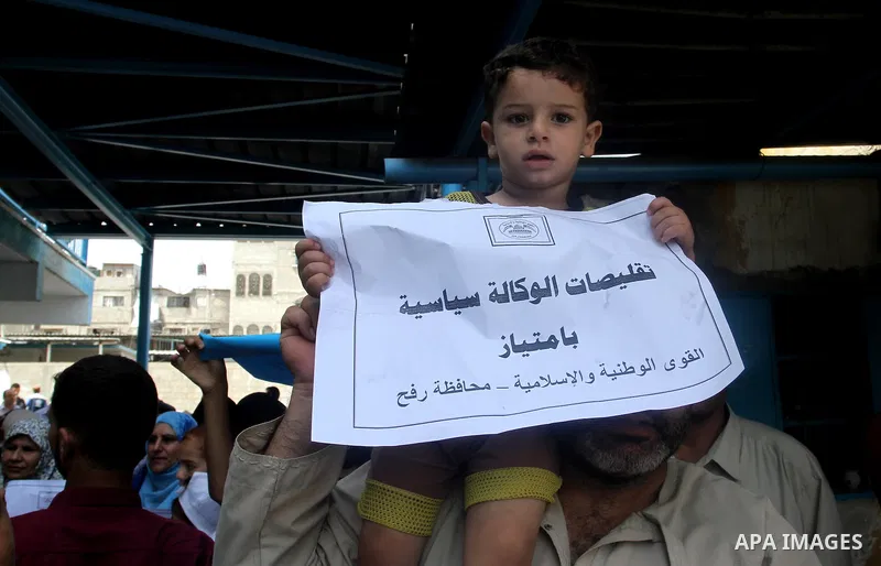 Palestinians take part in a protest against the UNRWA decision to reduce of the aid in Rafah in the southern Gaza strip on August 4, 2015. The United Nations Relief and Works Agency for Palestinians in the Near East (UNR...