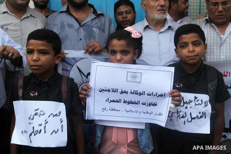 Palestinians take part in a protest against the UNRWA decision to reduce of the aid in Rafah in the southern Gaza strip on August 4, 2015. The United Nations Relief and Works Agency for Palestinians in the Near East (UNR...