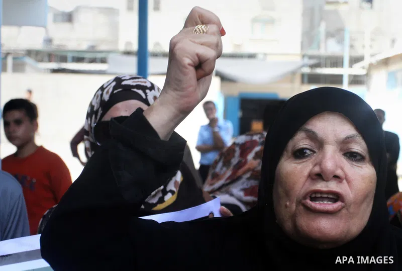 Palestinians take part in a protest against the UNRWA decision to reduce of the aid in Rafah in the southern Gaza strip on August 4, 2015. The United Nations Relief and Works Agency for Palestinians in the Near East (UNR...