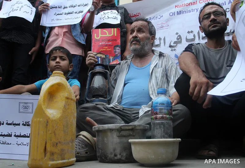 Palestinians take part in a protest against the UNRWA decision to reduce of the aid in Rafah in the southern Gaza strip on August 4, 2015. The United Nations Relief and Works Agency for Palestinians in the Near East (UNR...