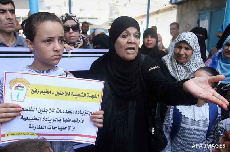 Palestinians take part in a protest against the UNRWA decision to reduce of the aid in Rafah in the southern Gaza strip on August 4, 2015. The United Nations Relief and Works Agency for Palestinians in the Near East (UNR...