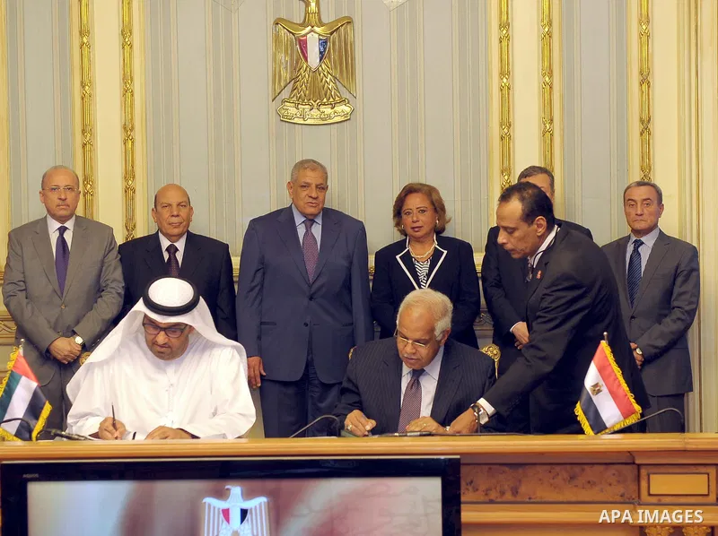 Egypt's Prime Minister Ibrahim Mahlab attends a signing ceremony with UAE minister of State Sultan Ahmed Al-Jaber, in Cairo on August 4, 2015. Mahlab, witnessed, today, the signings of delivery protocols for four of the...