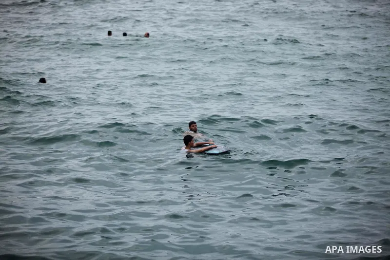 Palestinians swim in the Mediterranean Sea on the coast of Gaza City on August 4, 2015. Across the Middle East, temperatures in the high 30’s Centigrade (upper 90’s Fahrenheit) and as high as 50 (122 Fahrenheit) in some...