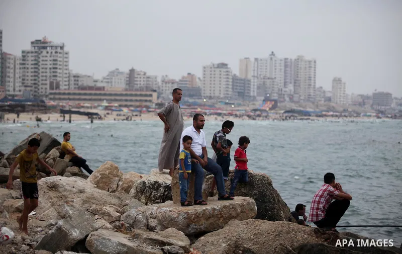 Palestinians enjoy the beach of the Mediterranean Sea on the coast of Gaza City on August 4, 2015. Across the Middle East, temperatures in the high 30’s Centigrade (upper 90’s Fahrenheit) and as high as 50 (122 Fahrenhei...