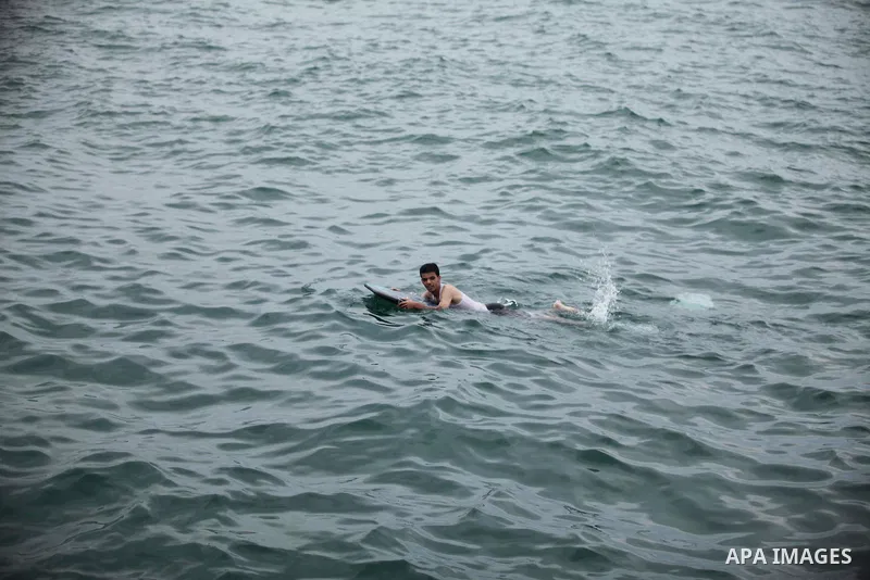 A Palestinian man swims in the Mediterranean Sea on the coast of Gaza City on August 4, 2015. Across the Middle East, temperatures in the high 30’s Centigrade (upper 90’s Fahrenheit) and as high as 50 (122 Fahrenheit) in...