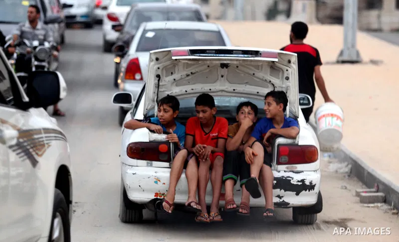 Palestinian children ride a car in front the Mediterranean Sea on the coast of Gaza City on August 4, 2015. Across the Middle East, temperatures in the high 30’s Centigrade (upper 90’s Fahrenheit) and as high as 50 (122...
