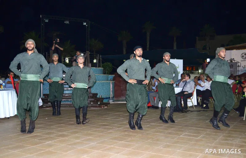 Palestinians perform during a reception ceremony of the Hebron's Al-Ahly team in Gaza city on August 4, 2015. The soccer teams of the Gaza Strip's Shejaia and al-Ahly from Hebron in the Israeli-occupied West Bank will pl...