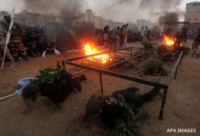 Palestinian youths demonstrate their skills during graduation ceremony of a military-style camp organized by the Hamas movement in Gaza City on August 5, 2015. Hamas's armed wing organized ''Liberation Youths Camps'' for...