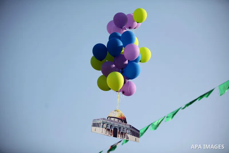 Ballons are released during a graduation ceremony of a military-style camp organized by the Hamas movement in Gaza City on August 5, 2015. Hamas's armed wing organized ''Liberation Youths Camps'' for young Palestinians a...