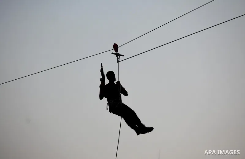 Palestinian youths demonstrate their skills during graduation ceremony of a military-style camp organized by the Hamas movement in Gaza City on August 5, 2015. Hamas's armed wing organized ''Liberation Youths Camps'' for...
