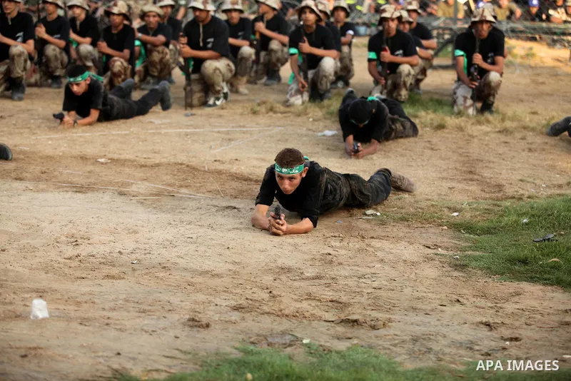 Palestinian youths demonstrate their skills during graduation ceremony of a military-style camp organized by the Hamas movement in Gaza City on August 5, 2015. Hamas's armed wing organized ''Liberation Youths Camps'' for...