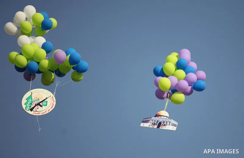 Ballons are released during a graduation ceremony of a military-style camp organized by the Hamas movement in Gaza City on August 5, 2015. Hamas's armed wing organized ''Liberation Youths Camps'' for young Palestinians a...