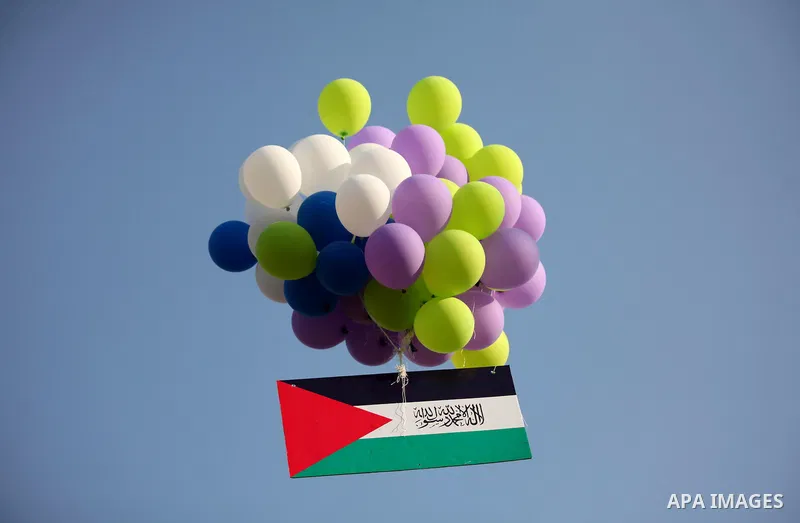 Ballons are released during a graduation ceremony of a military-style camp organized by the Hamas movement in Gaza City on August 5, 2015. Hamas's armed wing organized ''Liberation Youths Camps'' for young Palestinians a...