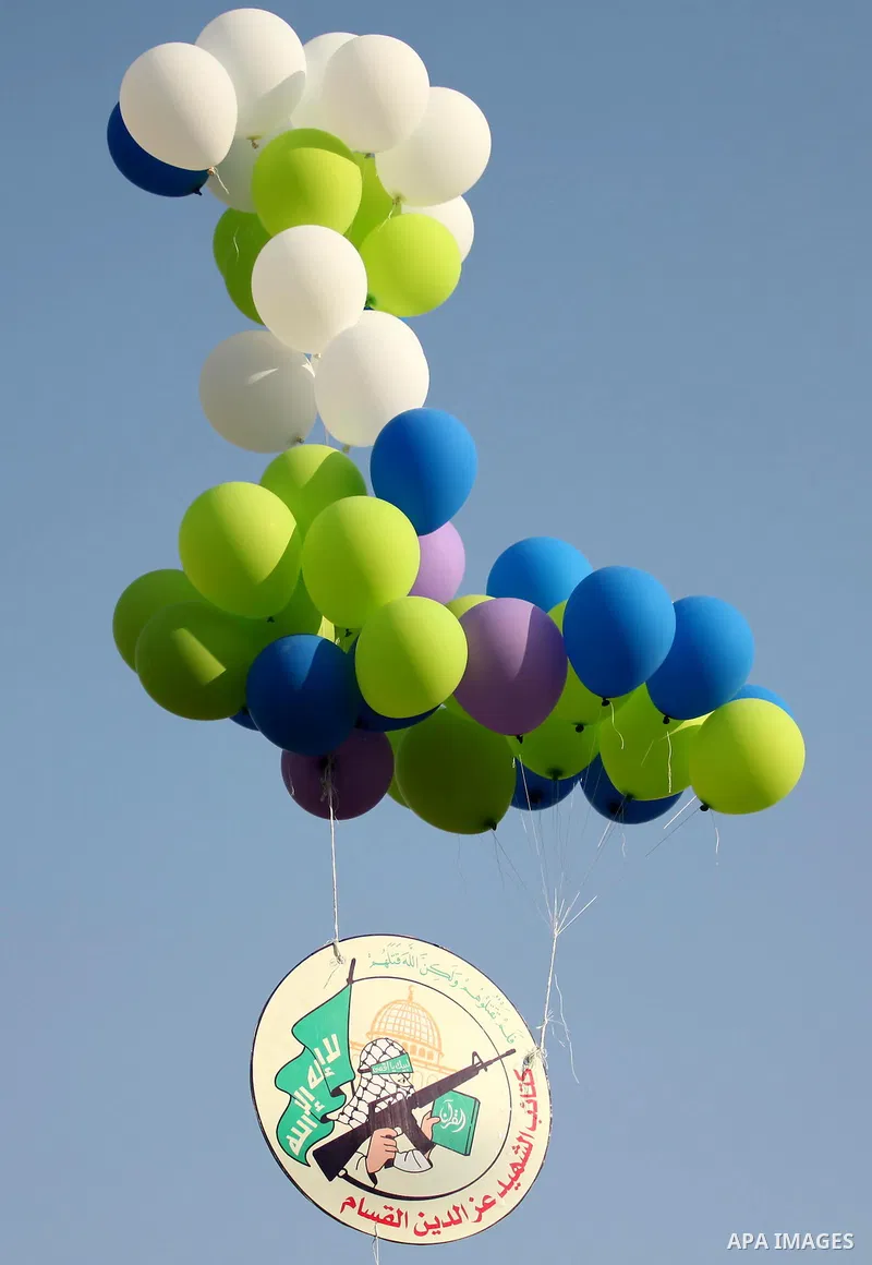 Ballons are released during a graduation ceremony of a military-style camp organized by the Hamas movement in Gaza City on August 5, 2015. Hamas's armed wing organized ''Liberation Youths Camps'' for young Palestinians a...