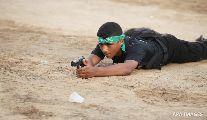 Palestinian youths demonstrate their skills during graduation ceremony of a military-style camp organized by the Hamas movement in Gaza City on August 5, 2015. Hamas's armed wing organized ''Liberation Youths Camps'' for...