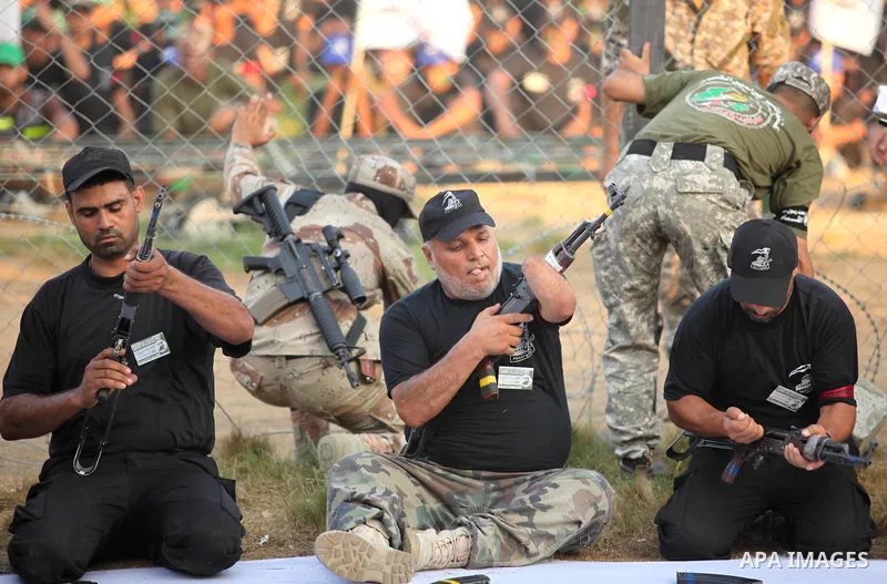 Palestinian men demonstrate their skills during graduation ceremony of a military-style camp organized by the Hamas movement in Gaza City on August 5, 2015. Hamas's armed wing organized ''Liberation Youths Camps'' for yo...