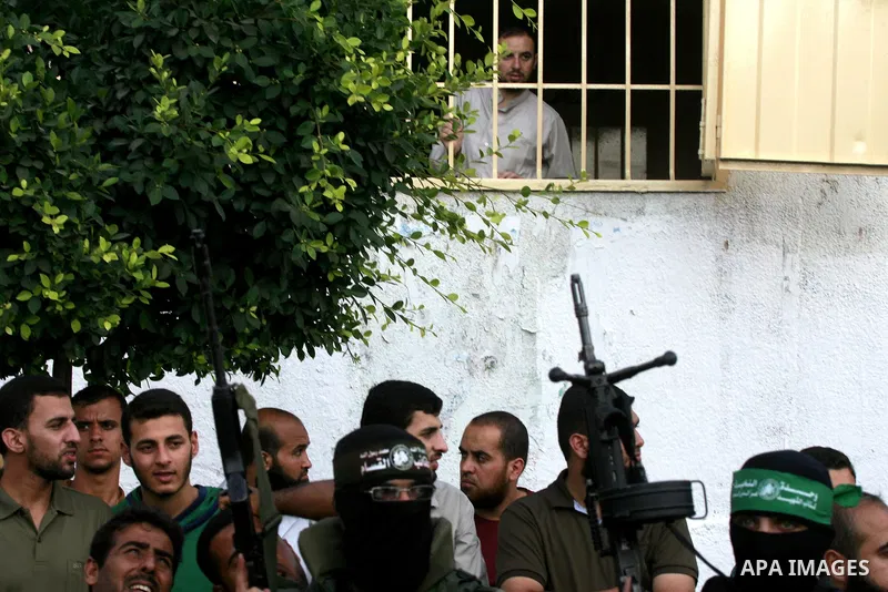 Members of Ezzedin al-Qassam Brigades, the armed wing of Hamas movement, take part in a graduation ceremony of a military-style camp organized by the Hamas movement in Khan Younis in the southern Gaza Strip, on August 5,...